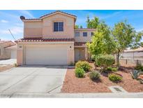 Charming two-story home featuring a red-tiled roof and a well-maintained front yard with low-lying shrubs and trees at 7909 Citrus Meadow Ct, Las Vegas, NV 89131
