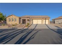Charming single-story home featuring a three-car garage and low-maintenance desert landscaping at 8228 Fulton Ranch St, Las Vegas, NV 89131