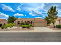 Charming single-story home featuring a tile roof, desert landscaping, and an attached two-car garage at 8525 Festival Dr, Las Vegas, NV 89134