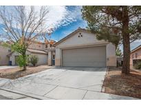 Charming home featuring a two-car garage and a well-maintained front yard at 9535 Golden Scots Ct, Las Vegas, NV 89123