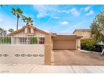Charming single-story home featuring a well-manicured yard and a two-car garage at 988 Flapjack Dr, Henderson, NV 89014