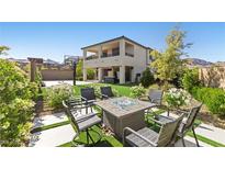 Inviting backyard with a modern fire pit, basketball court, and well-manicured landscaping, perfect for outdoor entertaining at 12413 Alpenglow Ct, Las Vegas, NV 89138