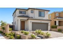 Charming two-story home featuring landscaped front yard, covered entry, and attached two-car garage at 12413 Alpenglow Ct, Las Vegas, NV 89138