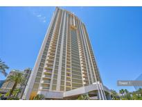 Modern high-rise building boasts sleek architecture, complemented by vibrant palm trees and clear blue skies at 145 E Harmon Ave # 3801&3803, Las Vegas, NV 89109