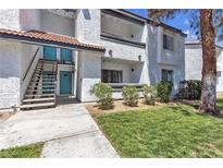 Condo exterior featuring stucco walls, a red tile roof, and well-maintained landscaping at 1455 E Katie Ave # D17, Las Vegas, NV 89119