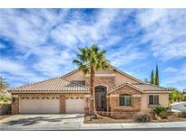 Charming single-story home featuring a three-car garage, desert landscaping, and a beautiful stone facade at 1532 Via Cassia, Henderson, NV 89052
