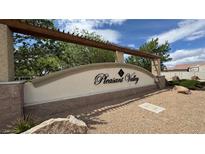Welcoming entrance to Pleasant Valley neighborhood with shaded pergola and stone accents at 2598 Fountain Ave, Pahrump, NV 89048