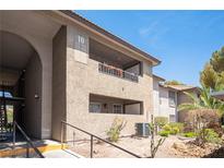 Exterior view of condo building with desert landscaping and stucco facade at 2606 S Durango Dr # 122, Las Vegas, NV 89117