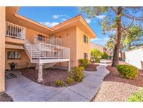 Charming two-story condo with landscaped front yard and walkway under a sunny blue sky at 2851 S Valley View Blvd # 2148, Las Vegas, NV 89102