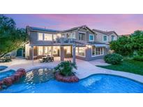 Stunning backyard featuring a pool, patio, and outdoor seating area perfect for entertaining in a two story home at 2940 Cimini Ct, Henderson, NV 89052