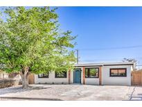 Charming single-story home featuring a minimalist landscaped yard, painted white stucco, and a welcoming blue front door at 333 Rossmoyne Ave, North Las Vegas, NV 89030