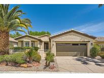 Charming single-story home featuring desert landscaping, mature palm tree, and attached two-car garage at 4552 Largo Cantata St, Las Vegas, NV 89135