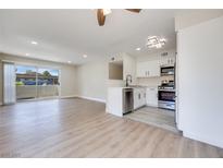 Bright living room blends seamlessly with the modern kitchen and stainless steel appliances at 5217 Caspian Springs Dr # 101, Las Vegas, NV 89120