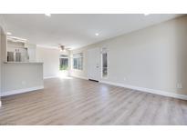 Bright, open living room with modern light wood floors and recessed lighting at 5217 Caspian Springs Dr # 101, Las Vegas, NV 89120