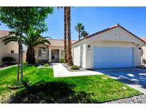 Charming single-story home featuring a well-maintained lawn and attached two-car garage at 5521 Desert Valley Dr, Las Vegas, NV 89149