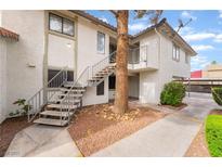 Inviting condo exterior with staircase access and well-maintained landscaping at 6711 W Charleston Blvd # 2, Las Vegas, NV 89146