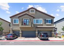 Charming townhouse with three garage doors and a small balcony at 7515 Emerald Stars St # 102, North Las Vegas, NV 89084