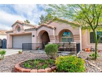 Charming single-story home with a well-maintained front yard and cozy porch seating area at 930 High Plains Dr, Henderson, NV 89002