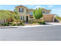 Charming stucco home with stone accents, a well-manicured landscape and a two-car garage at 12273 Catanzaro Ave, Las Vegas, NV 89138