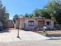 Exterior view of a single story home with a fenced yard and driveway at 1655 N Gateway Rd, Las Vegas, NV 89115