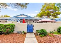 Charming home featuring a blue gate and well-maintained landscaping, creating an inviting curb appeal at 2040 Bavington Dr # D, Las Vegas, NV 89108