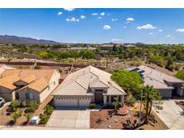 Spacious home boasts well-manicured landscaping and a neutral color palette, complemented by desert views at 2587 Grizzly Park Ct, Henderson, NV 89052