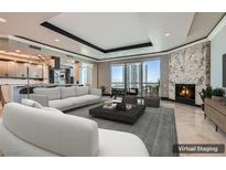 Bright, open living space with floor-to-ceiling windows and a modern fireplace, virtually staged for appeal at 2777 Paradise Rd # 2701, Las Vegas, NV 89109