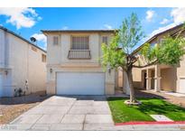Charming two-story home featuring stucco facade, attached two-car garage and a well-manicured front yard at 4321 Stockbridge St, Las Vegas, NV 89115