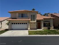 Two-story home featuring a two-car garage, desert landscaping and a red tile roof at 5024 Saint Annes Dr, Las Vegas, NV 89149