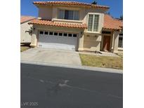Charming stucco home with a two-car garage, red tile roof, and well-manicured lawn at 5024 Saint Annes Dr, Las Vegas, NV 89149