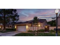 Charming single-story home with manicured lawn, attached garage, and beautiful evening sky at 5142 Southern Hills Ln, Las Vegas, NV 89113