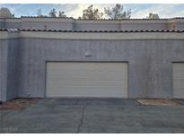 Attached garage door and exterior features a tiled roof in this multi-Gathering residence at 5250 S Rainbow Blvd # 1140, Las Vegas, NV 89118