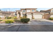 Charming two-story home with a well-manicured front yard and a three car attached garage at 5684 Benevento Ct, Las Vegas, NV 89141