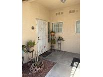 Inviting front entryway with charming plants, stone landscaping, and decorative security door at 7400 W Flamingo Rd # 1090, Las Vegas, NV 89147