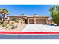 Inviting home with a three-car garage and desert landscaping for low maintenance in a sunny neighborhood at 7434 Eggshell Dr, North Las Vegas, NV 89084
