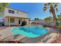 Inviting backyard oasis featuring a sparkling pool and lush tropical landscaping, perfect for relaxation and outdoor enjoyment at 8040 Tailwind Ave, Las Vegas, NV 89131