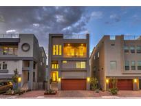 Modern three-story home showcasing a balcony, rooftop deck, and two-car garage with appealing landscaping at 8092 Haywood Estate Ave, Las Vegas, NV 89113