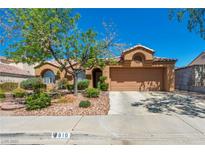 Charming single-story home with a well-maintained desert landscape and a spacious two-car garage at 819 Arrowhead Trl, Henderson, NV 89002