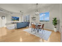 Bright living room featuring a ceiling fan, flatscreen TV, wood floors, and dining area at 8255 One Las Vegas Blvd # 504, Las Vegas, NV 89123