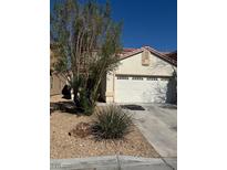 Single story home featuring desert landscaping, a two car garage, and a tile roof at 9664 Toy Soldier St, Las Vegas, NV 89178