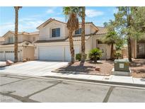 Charming two-story home featuring a three car garage and desert landscaping in a suburban neighborhood at 9923 Sierra Canyon Way, Las Vegas, NV 89147