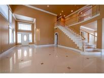 Bright, expansive foyer boasts high ceilings, tile floors, and a grand staircase leading to the upper level at 9923 Sierra Canyon Way, Las Vegas, NV 89147