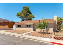 Charming single-story home features a red tile roof and well-manicured landscaping at 100 Walker Way, Boulder City, NV 89005