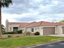 Charming single-story home with well-maintained lawn, desert landscaping, and an attached two car garage at 1198 Golf Club, Laughlin, NV 89029