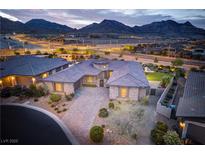 Stunning home featuring manicured landscaping and tile roofing set against a mountain backdrop at 12168 Dorada Coast Ave, Las Vegas, NV 89138