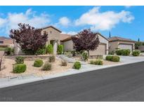 Charming single-story home with desert landscaping, mature trees and a welcoming front entrance at 2244 Shadow Canyon Dr, Henderson, NV 89044