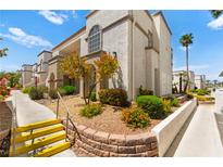 Charming condo building featuring well-maintained landscaping and exterior staircase at 3150 Soft Breezes Dr # 1037, Las Vegas, NV 89128
