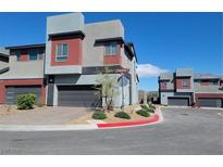 Modern two-story home features a gray exterior with red accents, a garage, and manicured landscaping at 3210 Centano Ave, Henderson, NV 89044