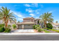 Charming two-story home featuring a three-car garage, desert landscaping and mature palm trees at 364 Clark Dr, Henderson, NV 89074