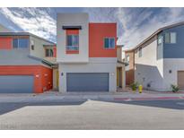 Charming two-story home with modern design, grey garage door, and red accent wall at 4349 Tabor Peak Ave, Las Vegas, NV 89141